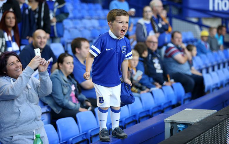 A young Everton fan shouts his encouragement