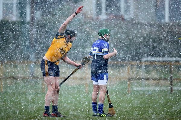 Rob Lennon and Jack Hobbs try and warm their hands during a snow shower 11/2/2014