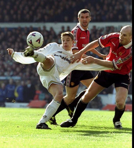 Alan Smith of Leeds United  is Challenged by Jaap Stam of Manchester United