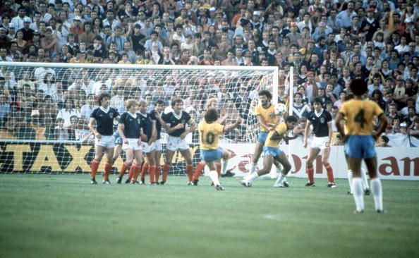 1982 World Cup Finals. Seville, Spain. 18th June, 1982. Brazil 4 v Scotland 1. Brazil's Zico (10) bends the ball around the Scottish wall to score their first goal from a free kick