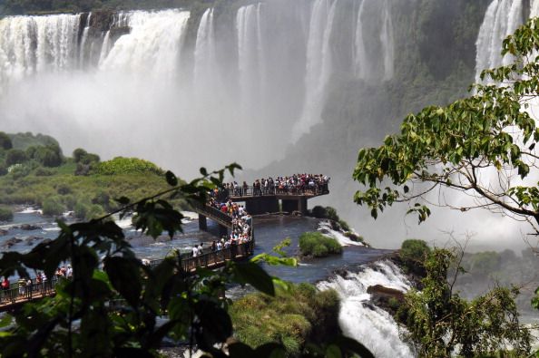 Tourists walk on a bridge on the Brazili