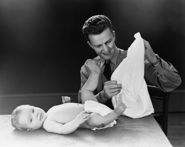Father changing baby's nappy