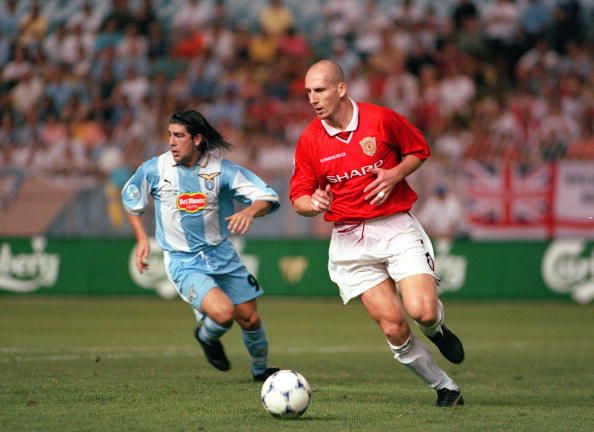 1999 UEFA Super Cup Final. Monaco. 27th August, 1999. Lazio 1 v Manchester United 0. Manchester United's Jaap Stam on the ball chased by Lazio's Marcelo Salas.