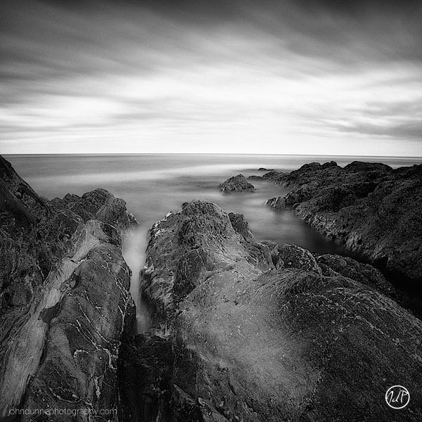 The rock formations at Greystones jut out in to the Irish Sea as the clouds sweep in overhead.