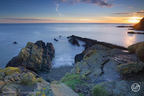 The sun has just crested the horizon sending its warm golden light down to Naylor's Cove in Bray, Co. Wicklow