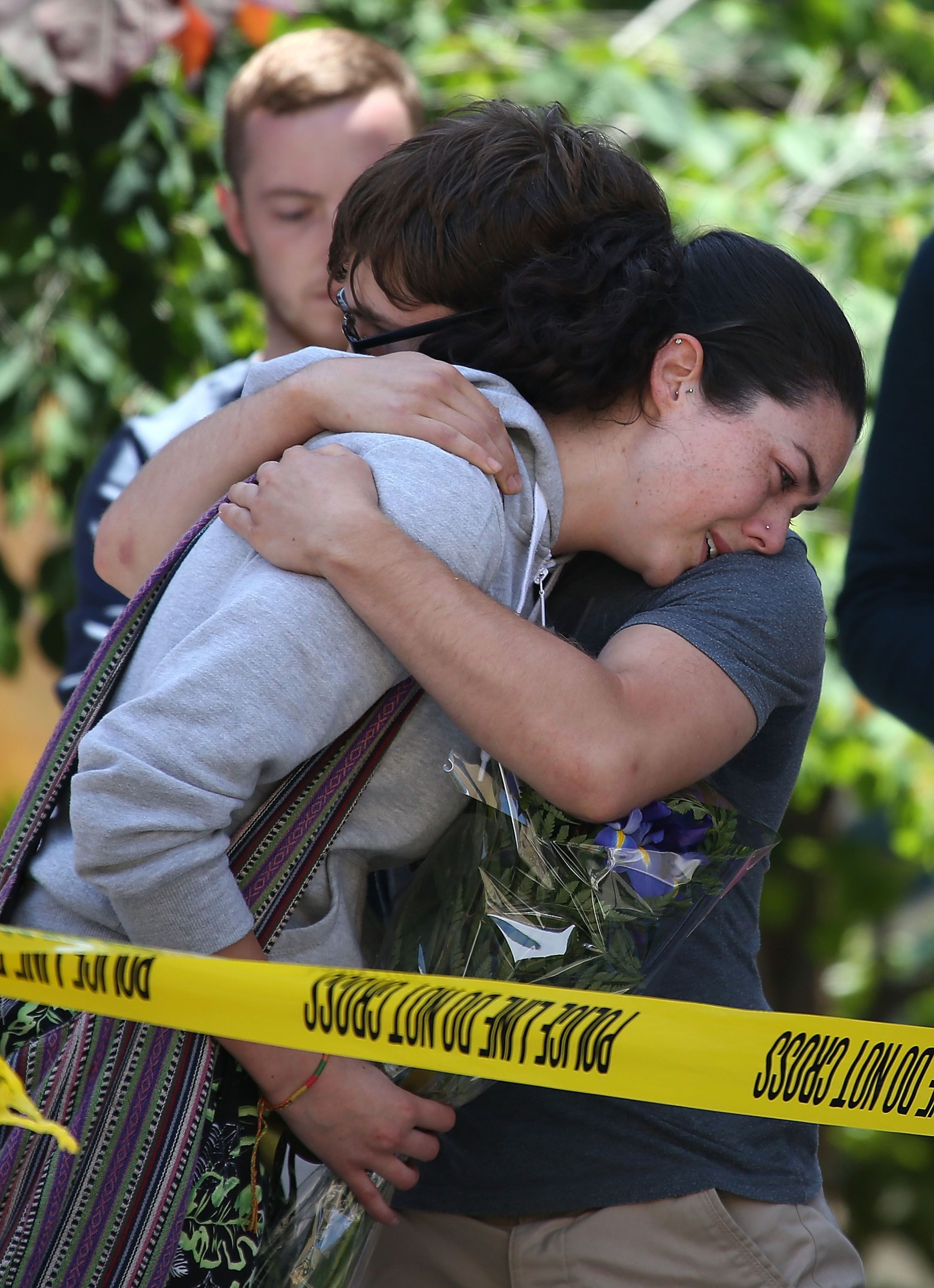 BERKELEY, CA - JUNE 16: A woman cries as she leaves flowers at the scene of a balcony collapse at an apartment building near UC Berkeley on June 16, 2015 in Berkeley, California. 6 people were killed and 7 were seriously injured when a balcony collapsed at an apartment building near the University of California at Berkeley campus. (Photo by Justin Sullivan/Getty Images)