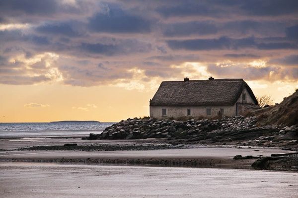 A view of an old cottage (the Nanny Cottage) at the mouth of the Nanny river at dawn in Laytown