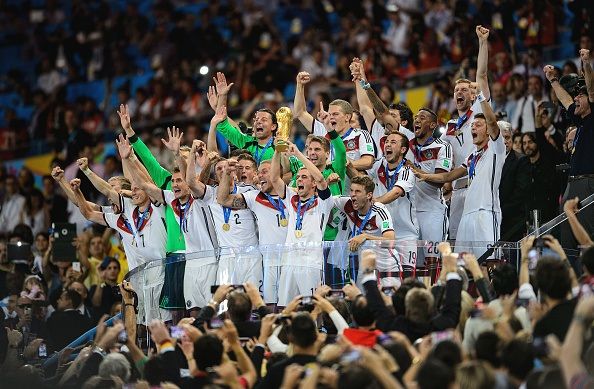 RIO DE JANEIRO, BRAZIL - JULY 13: Philipp Lahm of Germany lifts the World Cup trophy with teammates after defeating Argentina 1-0 in extra time during the 2014 FIFA World Cup Brazil Final match between Germany and Argentina at Maracana on July 13, 2014 in Rio de Janeiro, Brazil. (Photo by Matthias Hangst/Getty Images)