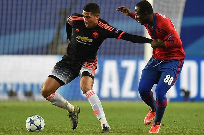 KHIMKI, RUSSIA - OCTOBER 21: Seydou Doumbia (R) of CSKA Moscow in action against Chris Smalling of Manchester United FC during the UEFA Champions League Group B match between CSKA Moscow and Manchester United FC at the Arena Khimki Stadium on October 21, 2015 in Moscow, Russia.  (Photo by Epsilon/Getty Images)