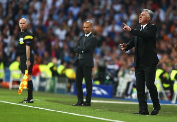 MADRID, SPAIN - APRIL 23: Carlo Ancelotti, coach of Real Madrid gives instructions with Josep Guardiola , coach of Bayern Muenchen during the UEFA Champions League semi-final first leg match between Real Madrid and FC Bayern Muenchen at the Estadio Santiago Bernabeu on April 23, 2014 in Madrid, Spain. (Photo by Paul Gilham/Getty Images)