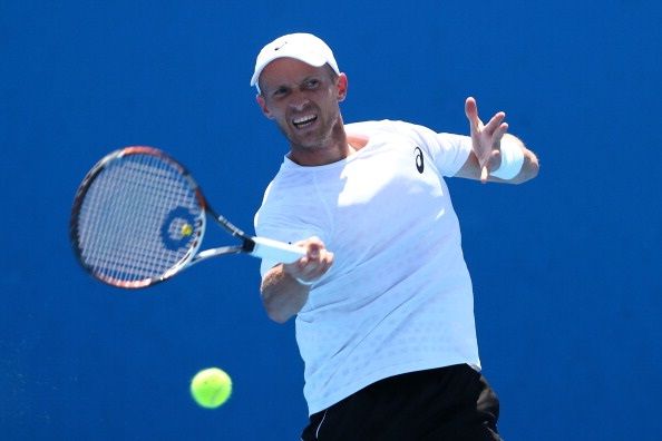 MELBOURNE, AUSTRALIA - JANUARY 16: Nikolay Davydenko of Russia plays a forehand in his first round doubles match with Andrey Golubev of Kazakhstan against Christopher Kas of Germany and Robin Haase of the Netherlands during day four of the 2014 Australian Open at Melbourne Park on January 16, 2014 in Melbourne, Australia. (Photo by Renee McKay/Getty Images)