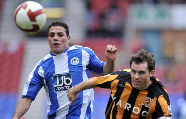Wigan's Amir Zaki (L) vies with Hull's Kevin Kilbane during their English Premiership football match at The JJB Stadium, in north-west England on March 22, 2009. AFP PHOTO / HOWARD WALKER FOR EDITORIAL USE ONLY Additional licence required for any commercial/promotional use or use on TV or internet (except identical online version of newspaper) of Premier League/Football League photos. Tel DataCo +44 207 2981656. Do not alter/modify photo (Photo credit should read HOWARD WALKER/AFP/Getty Images)