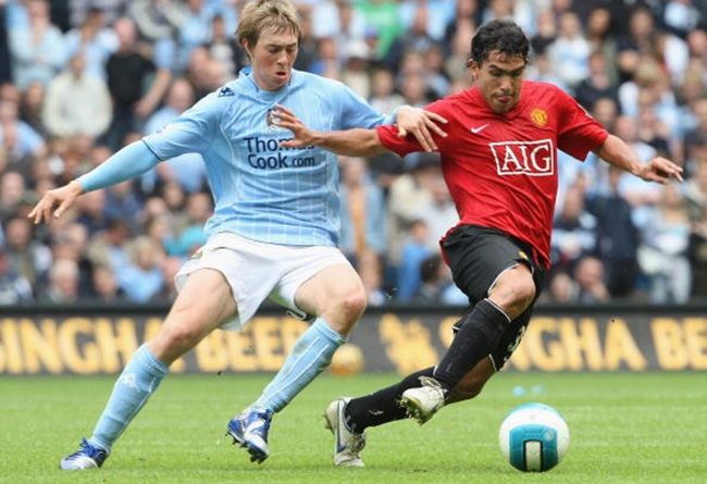 MANCHESTER, ENGLAND - AUGUST 19: Carlos Tevez of Manchester United clashes with Michael Johnson of Manchester City during the Barclays Premier League match between Manchester City and Manchester United at City of Manchester Stadium on August 19 2007 in Manchester, England. (Photo by John Peters/Manchester United via Getty Images)