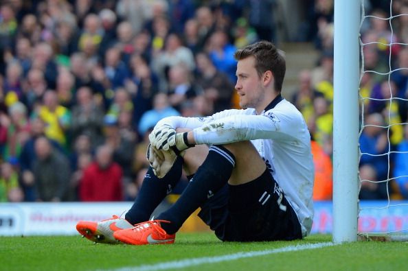 NORWICH, ENGLAND - APRIL 20: A dejected Simon Mignolet of Liverpool sits on the pitch after conceding a second goal during the Barclays Premier League match between Norwich City and Liverpool at Carrow Road on April 20, 2014 in Norwich, England. (Photo by Michael Regan/Getty Images)