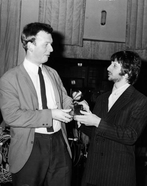 British recording engineer and producer Geoff Emerick (left) accepts a Grammy Award (for Best Engineered Recording - Non-Classical) from British drummer Ringo Starr, whose group, the Beatles, recorded the record Emerick engineered, March 8, 1968. (Photo by Express Newspapers/Getty Images)