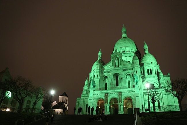 A picture taken on March 16, 2016 in Paris shows the green illuminated basilica of the sacred heart (Sacre Coeur) on the top of the Montmartre hill in celebration of Saint Patrick's Day. / AFP / LUDOVIC MARIN (Photo credit should read LUDOVIC MARIN/AFP/Getty Images)