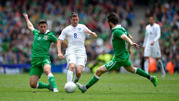DUBLIN, IRELAND - JUNE 07: England player James Milner (c) is challenged by Shane Long (l) and Harry Arter during the International friendly match between Ireland and England at Aviva Stadium on June 7, 2015 in Dublin, Ireland. (Photo by Stu Forster/Getty Images)