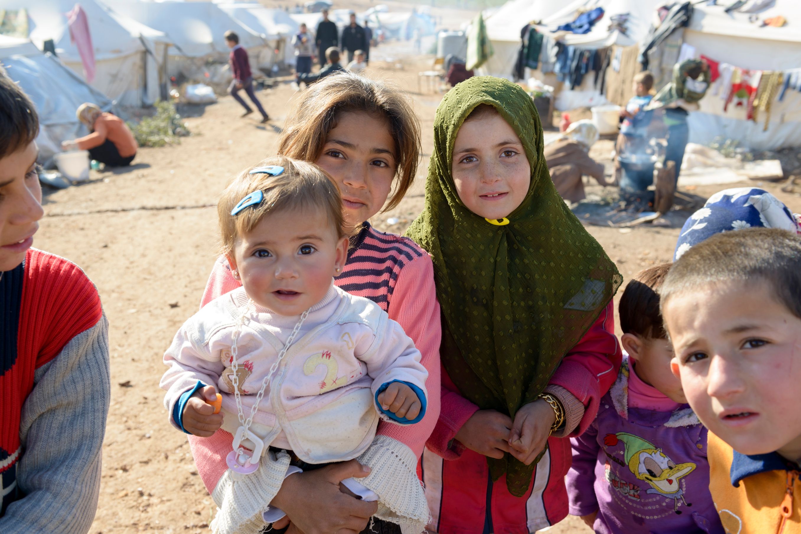 Atmeh, Syria - January 14, 2013: Internally displaced Syrians, including children, at a refugee camp near the Turkish border in Atmeh, Syria