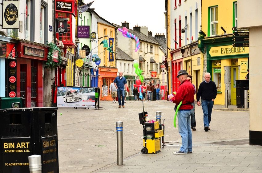"Galway, Ireland - May 1, 2011: Man selling balloons in the main shopping area (&quot;Latin Quarter&quot;) in Galway. Along it you can find all kinds of shops, pubs and restaurants."