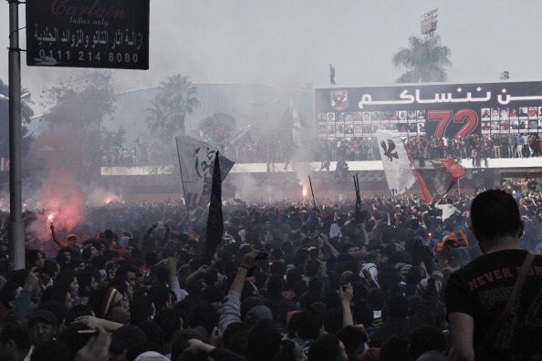 CAIRO, EGYPT - JANUARY 26: Egyptian 'Ahly Ultra' soccer fans gather at the Al Ahly home stadium during celebrations after the announcement that 21 fans of the Al Masry football club involved in a football stadium massacre last year were sentence to death on January 26, 2013 in Cairo, Egypt. A verdict was announced Saturday in a case over the deaths of more than seventy fans of Egypt's Al-Ahly football club in a stadium massacre on February 1, 2012, in the northern city of Port Said, during a riot that began minutes after the final whistle of a match between Al-Ahly and Al-Masry. 21 fans of the Al Masry football club were given the death penalty in the court case, a verdict that must now be approved by Egypt's Grand Mufti. The verdict was handed down during a period of high tension across Egypt, one day after the second anniversary of the beginning of Egypt's 2011 revolution that overthrew the regime of former President, Hosni Mubarak. (Photo by Ed Giles/Getty Images)