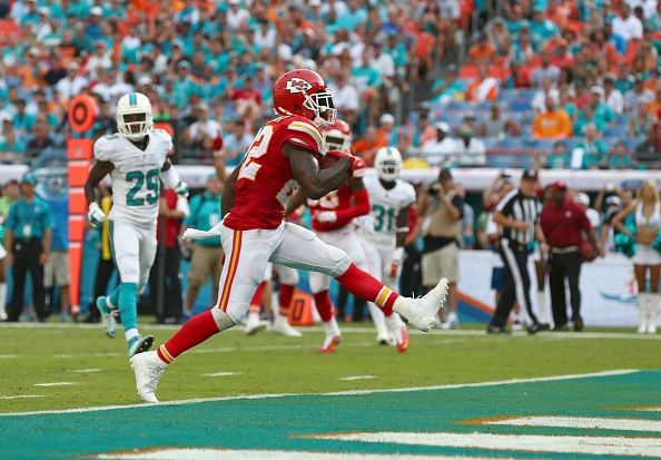 MIAMI GARDENS, FL - SEPTEMBER 21: Running back Joe McKnight #22 of the Kansas City Chiefs scores a third-quarter touchdown against the Miami Dolphins at Sun Life Stadium on September 21, 2014 in Miami Gardens, Florida. (Photo by Ronald Martinez/Getty Images)
